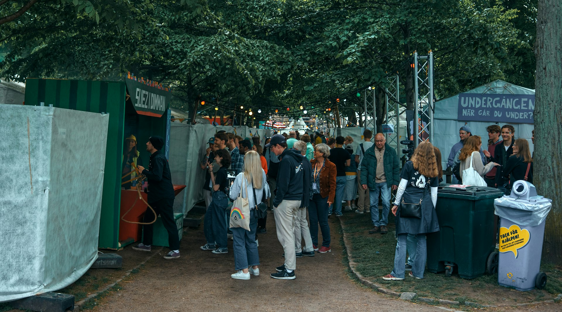 a group of people standing around a tent